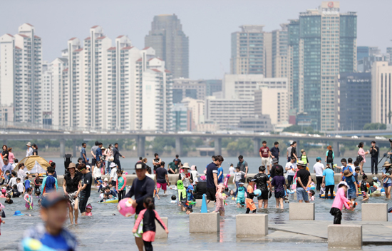 전국 대부분 지역에 폭염특보가 내려진 24일 서울 여의도 물빛광장이 물놀이를 즐기는 시민들로 붐비고 있다. /연합뉴스